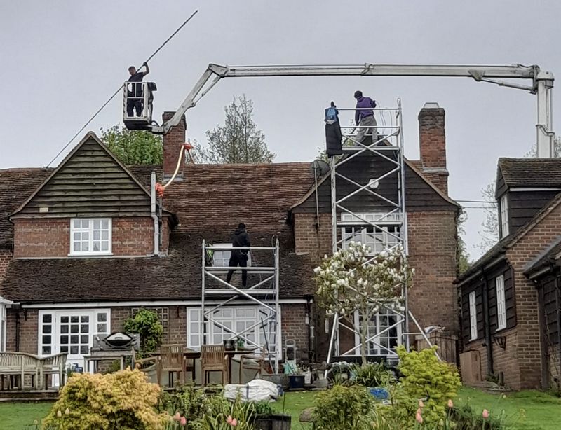 The Roof Moss Cleaners using cherry picker and scaffolding to clean roof safely and professionally in Hoddesdon, Hertfordshire